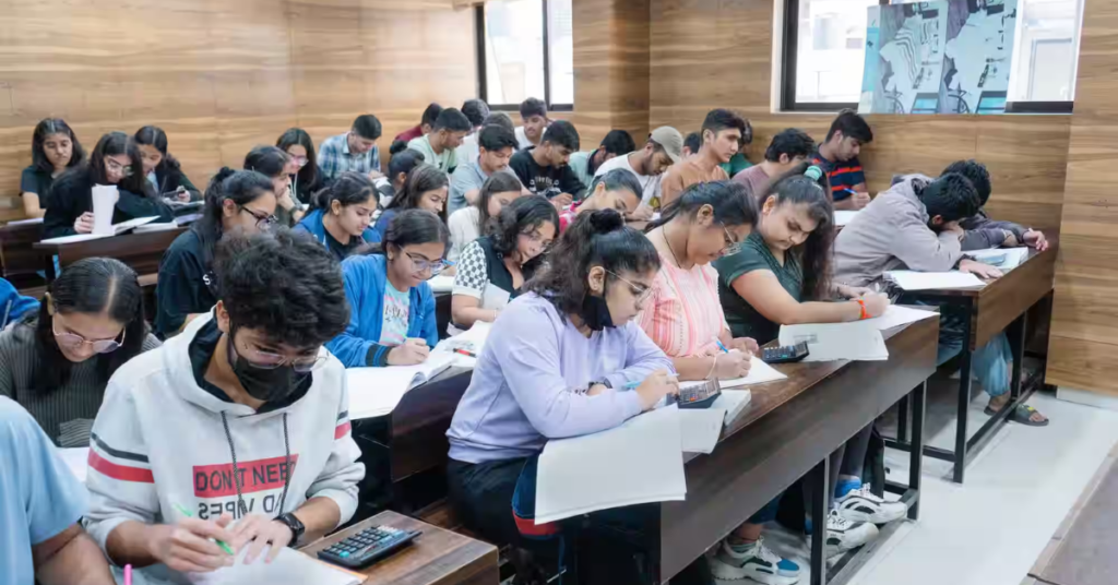 Group of students studying in a coaching institute classroom in Rajasthan, reflecting new regulation for student welfare and support.